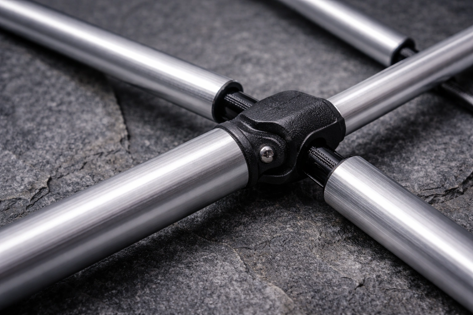 Close-up of brushed silver anodized aluminum poles connected by shock cord with reinforced nylon hub joint