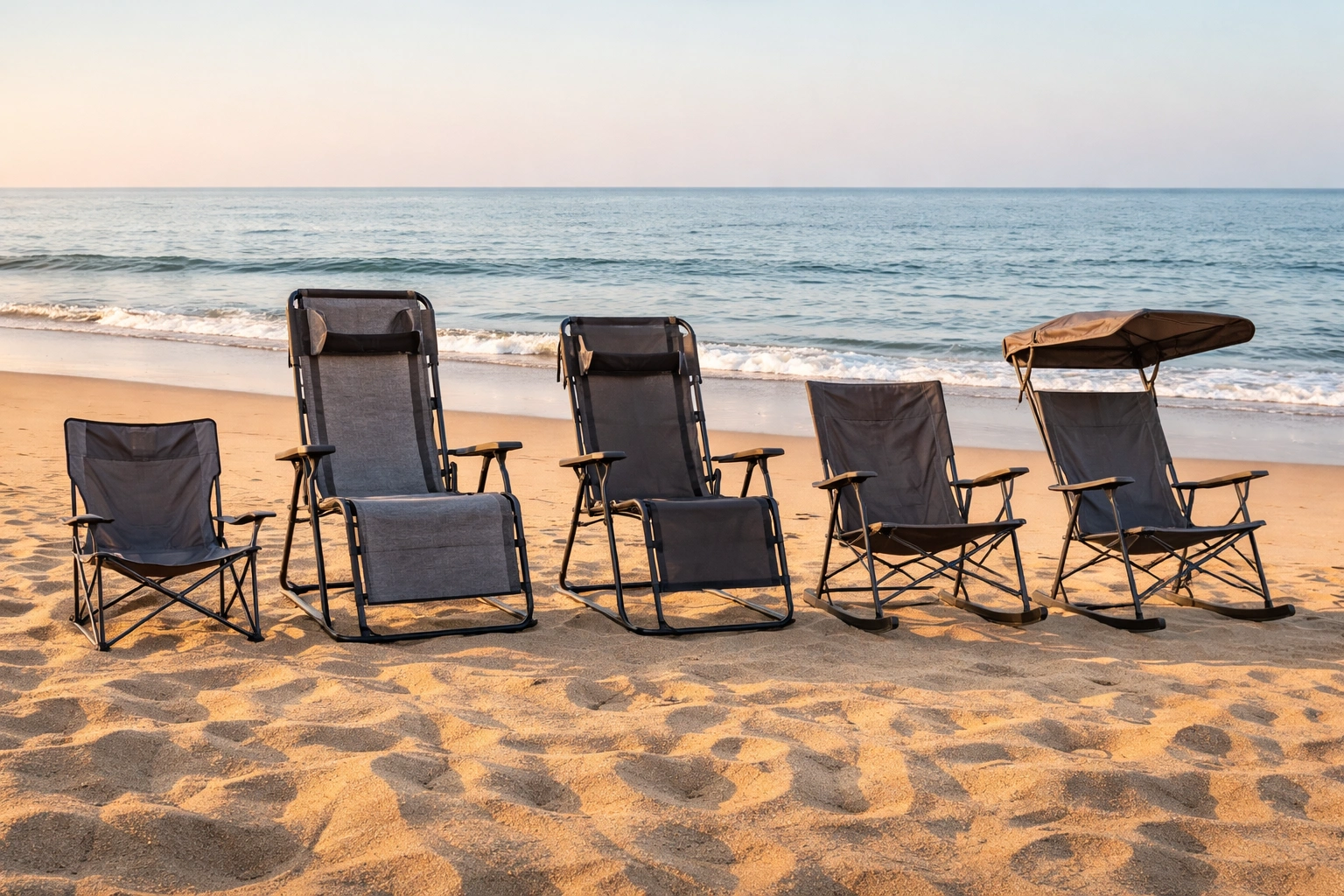 Five different empty beach chair styles lined up on sand facing the ocean including low-back high-back zero-gravity rocking and canopy models