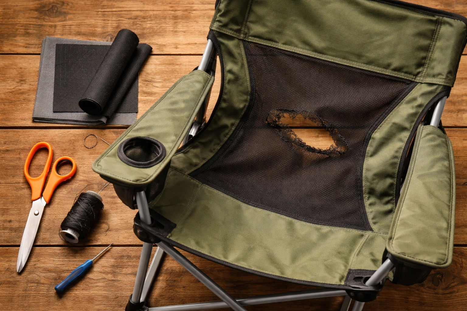 Flat lay of camping chair repair tools fabric patch kit scissors and screwdriver