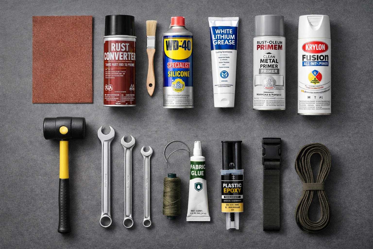Flat lay of camping chair repair supplies including sandpaper rust converter spray primer paint WD-40 lithium grease wrench set nylon thread upholstery needle fabric glue plastic epoxy and webbing strap