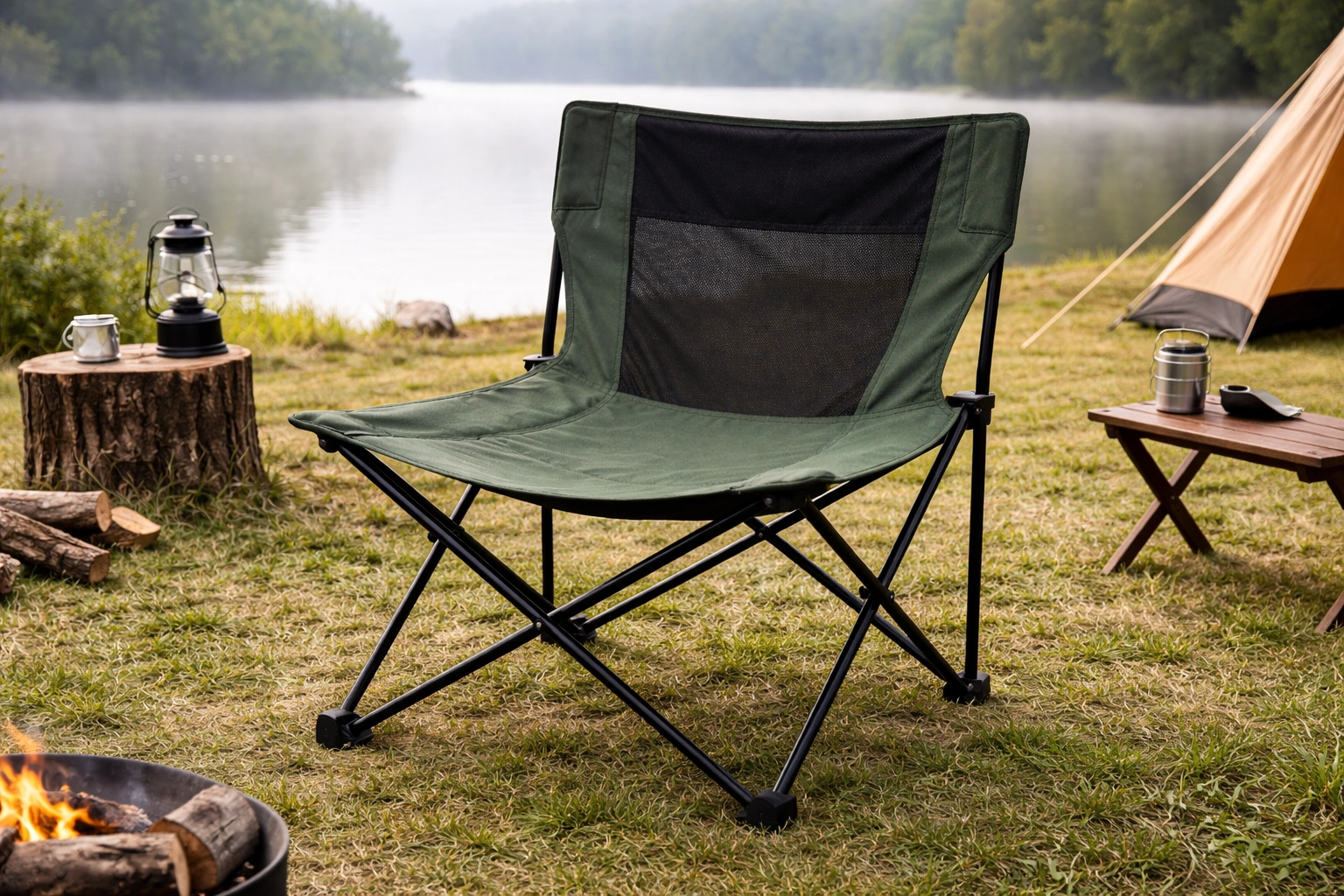 Wider taller pole-frame camping chair with larger seat base and taller back set up at lakeside campsite with morning mist on lake