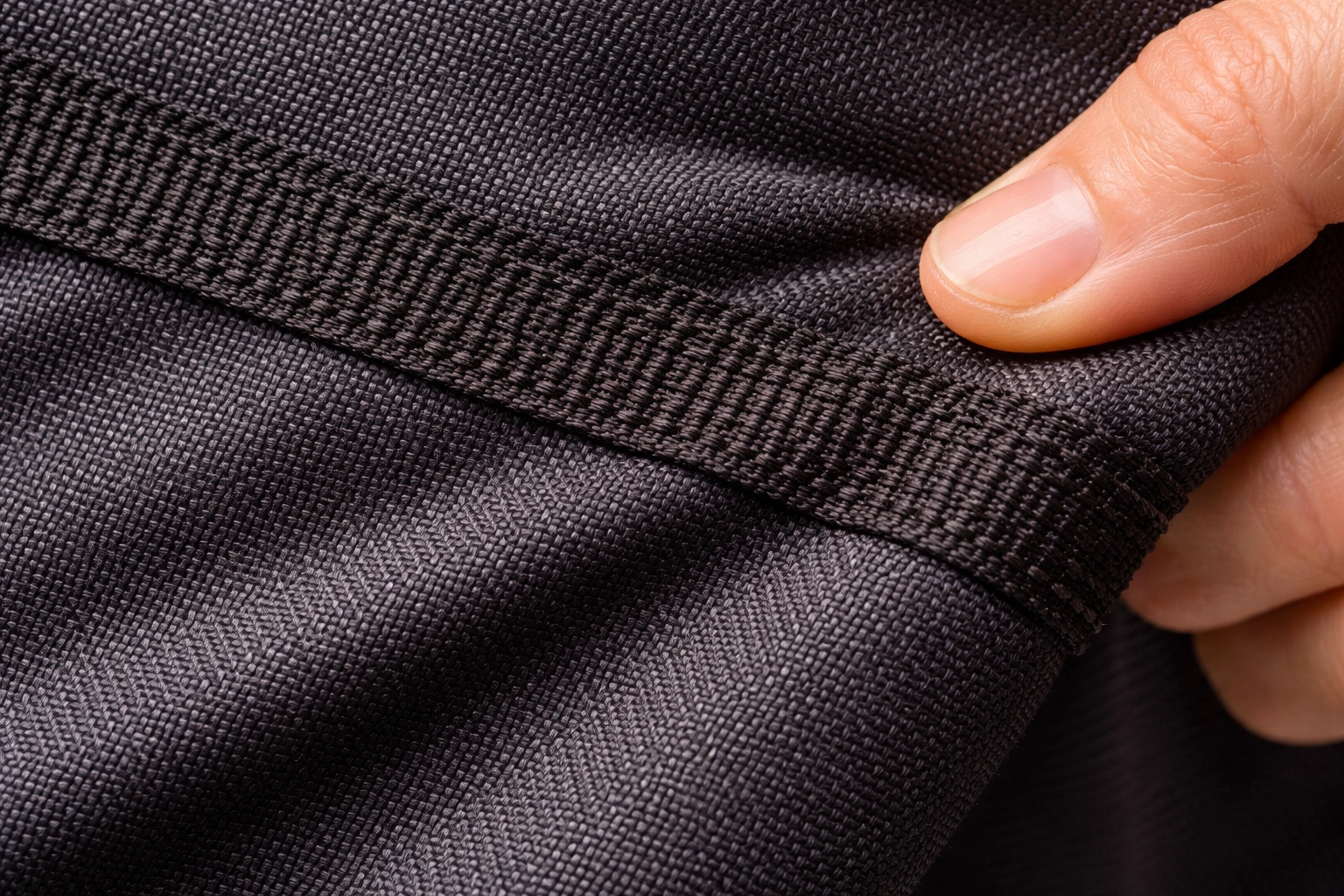 Close-up of high denier 900D polyester fabric with reinforced stitching