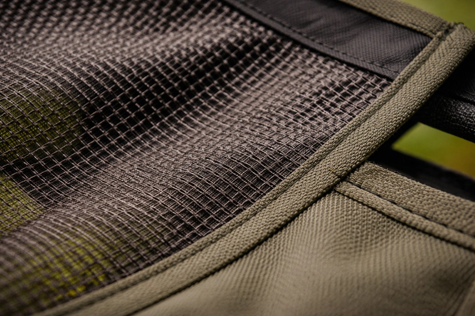 Close-up of polyester mesh fabric texture on camping chair seat showing weave pattern