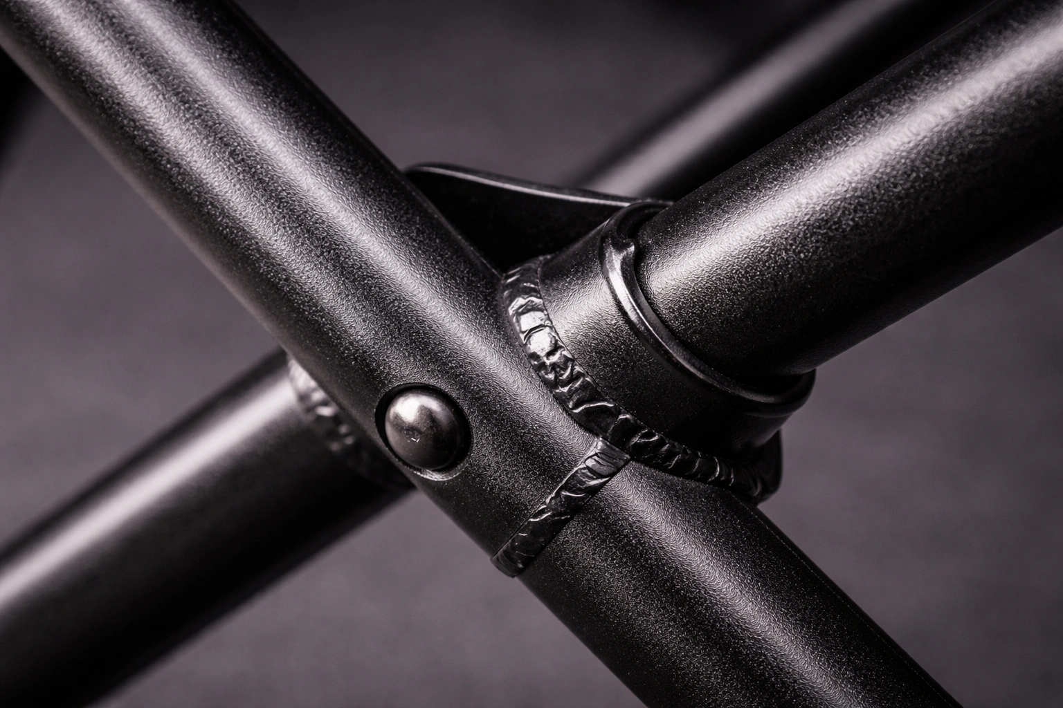 Close-up detail of powder-coated steel camping chair frame joints and cross bars