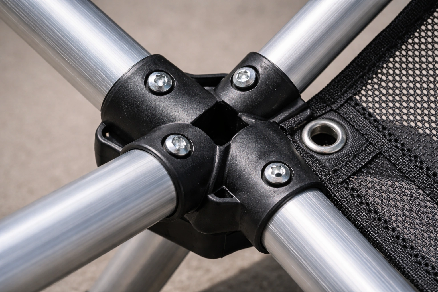 Close-up detail of aluminum frame joints and mesh fabric stitching on premium camping chair