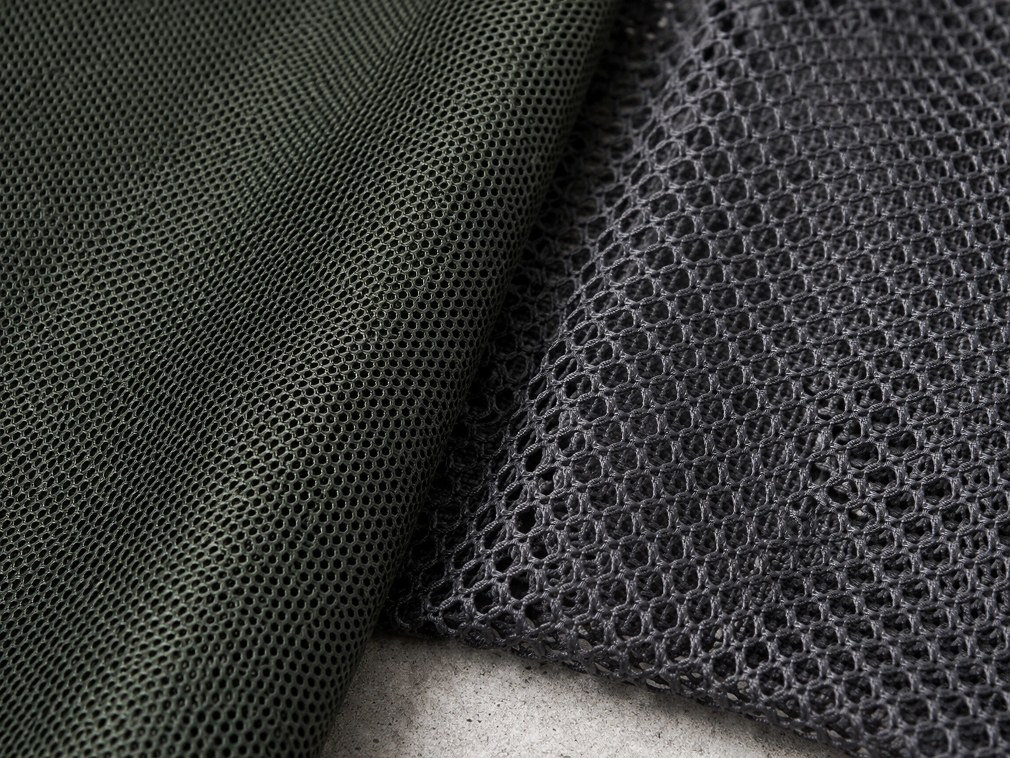 Close-up texture of breathable mesh fabric with visible weave pattern