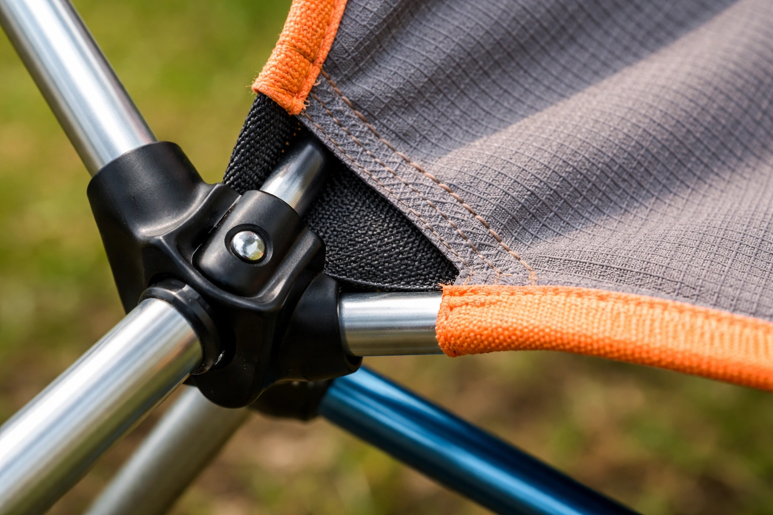 Close up of ultralight camping chair showing aluminum frame and ripstop polyester fabric