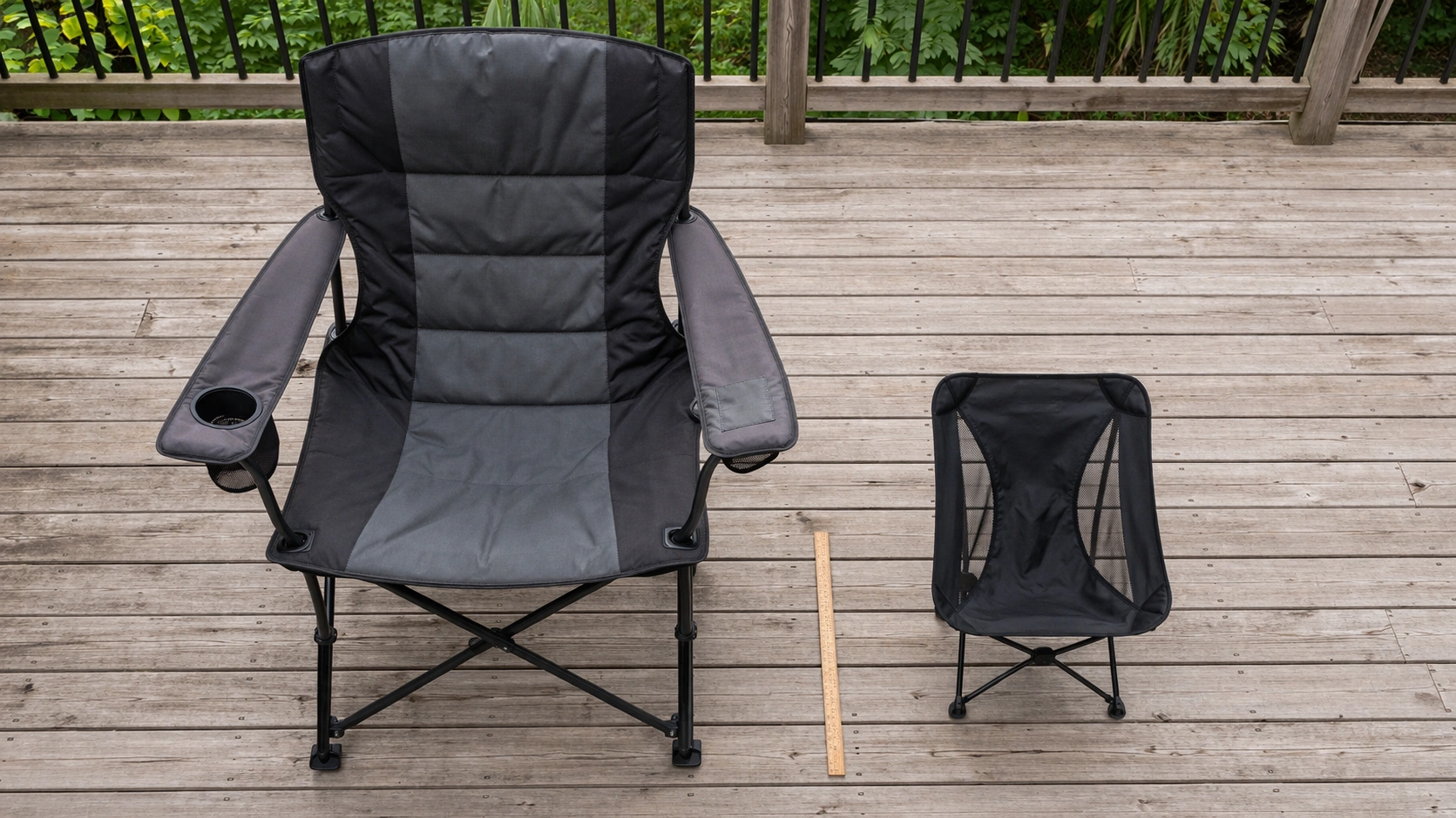Two camping chairs side by side on wooden deck showing dramatic size difference between large heavy-duty chair and compact lightweight chair with ruler for scale